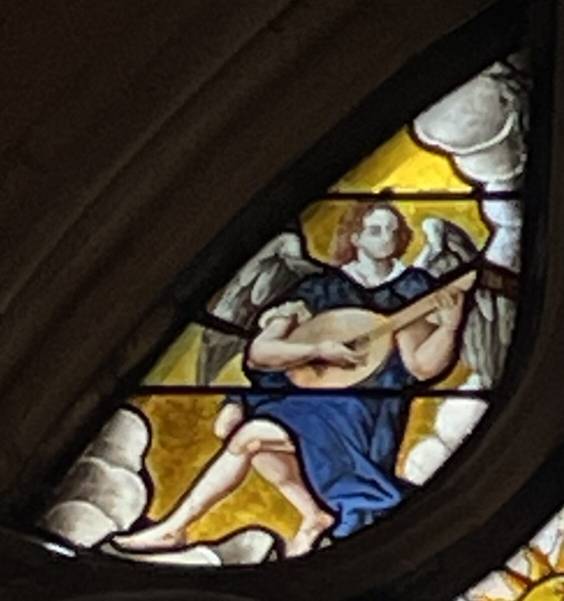 Vitrail de la baie 3 "Déploration du Christ" Après restauration - Ange musicien, joueur de luth, dans l'écoinçon gauche. 